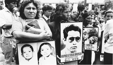 Families with pictures of loved ones at a demonstration in Quito, circa 1989. The Ecuadoran people look to the government for protection, but also expect corruption.